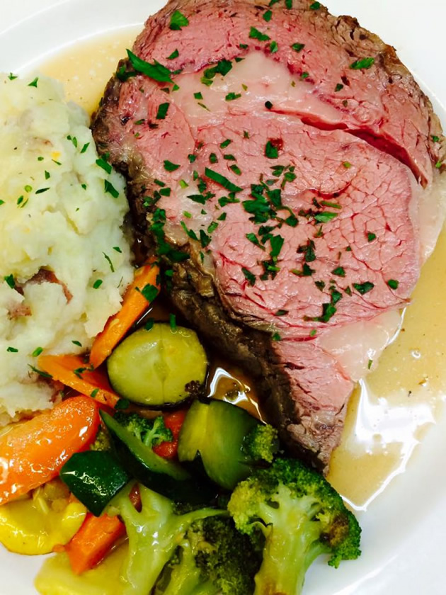 Thick cut prime rib with mashed potato and vegetables