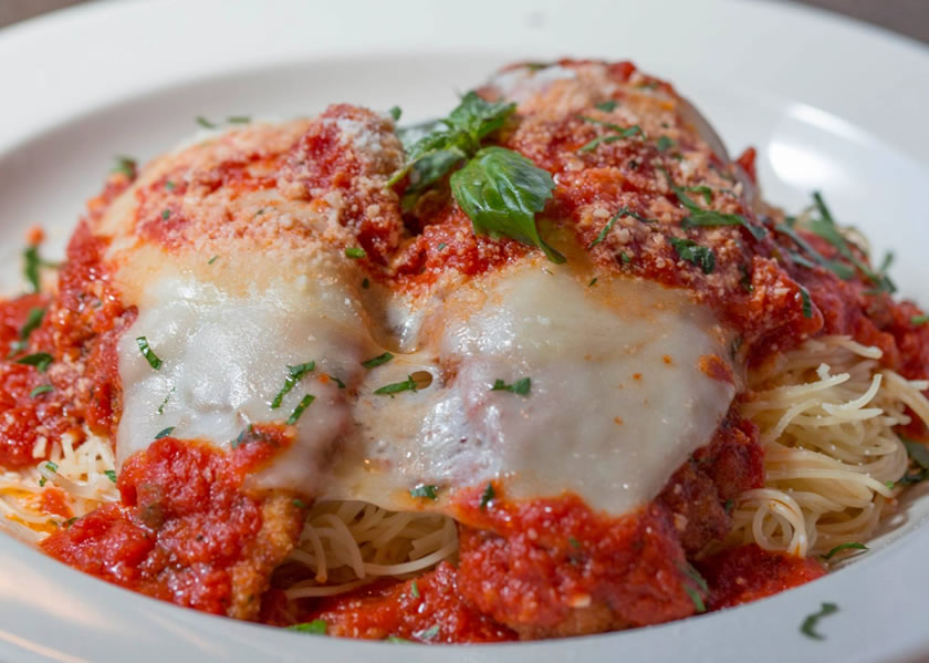 Chicken parmesan with thick marinara sauce and melted mozzarella