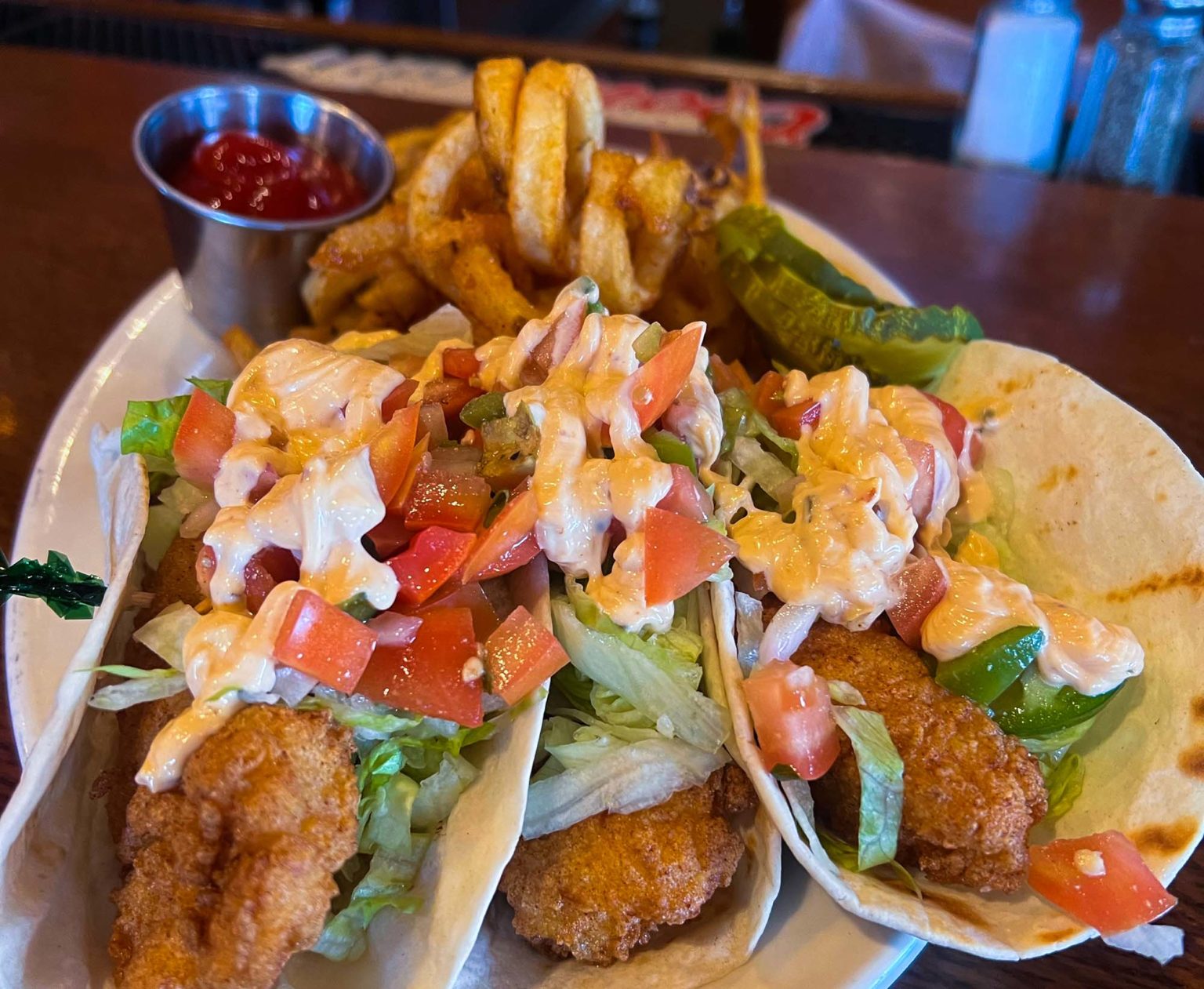 Fried haddock fish tacos with pico de gallo and curly fries
