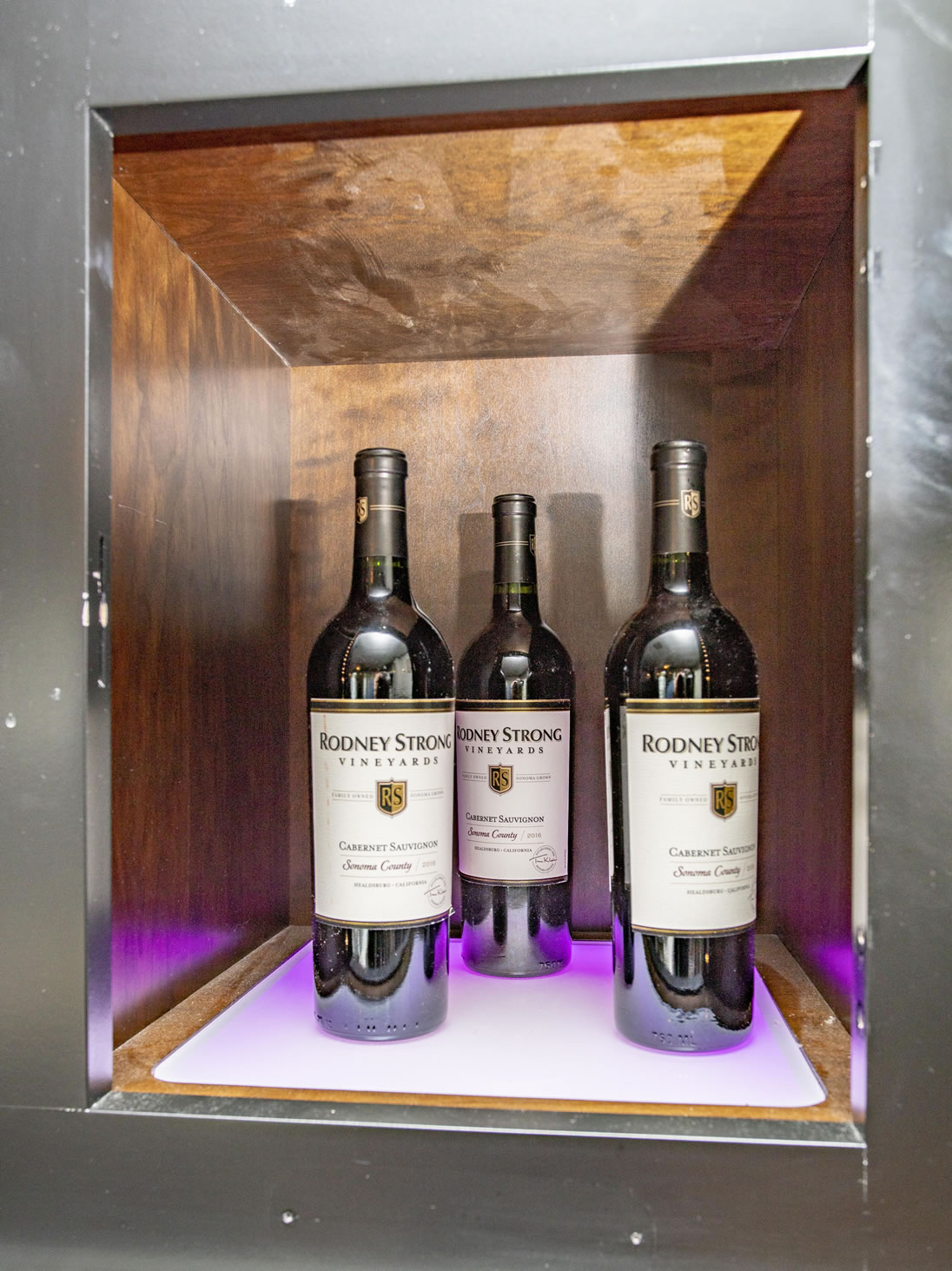Bottles of wine displayed in a wooden shelf
