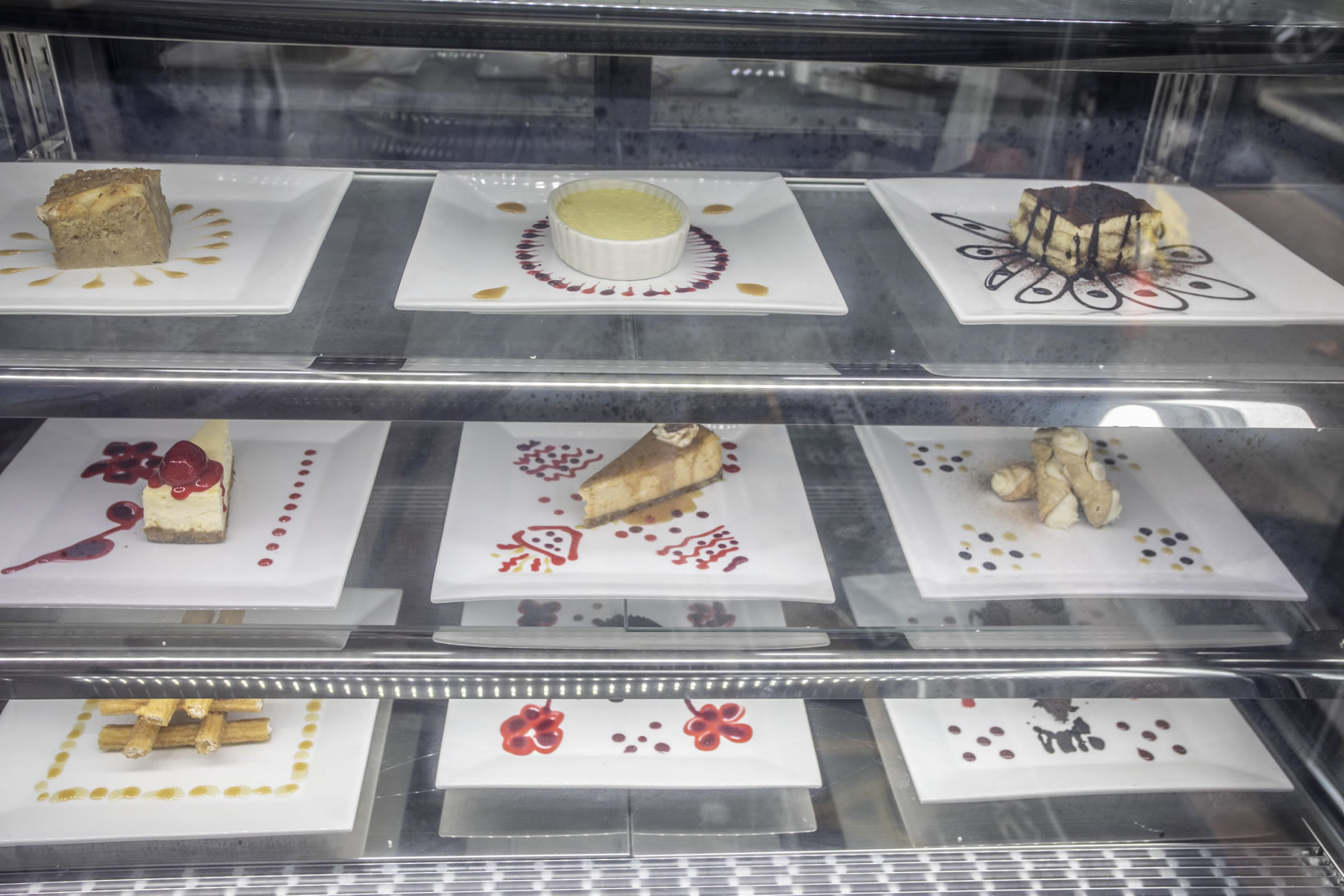 Dessert display case filled with cakes and pastries