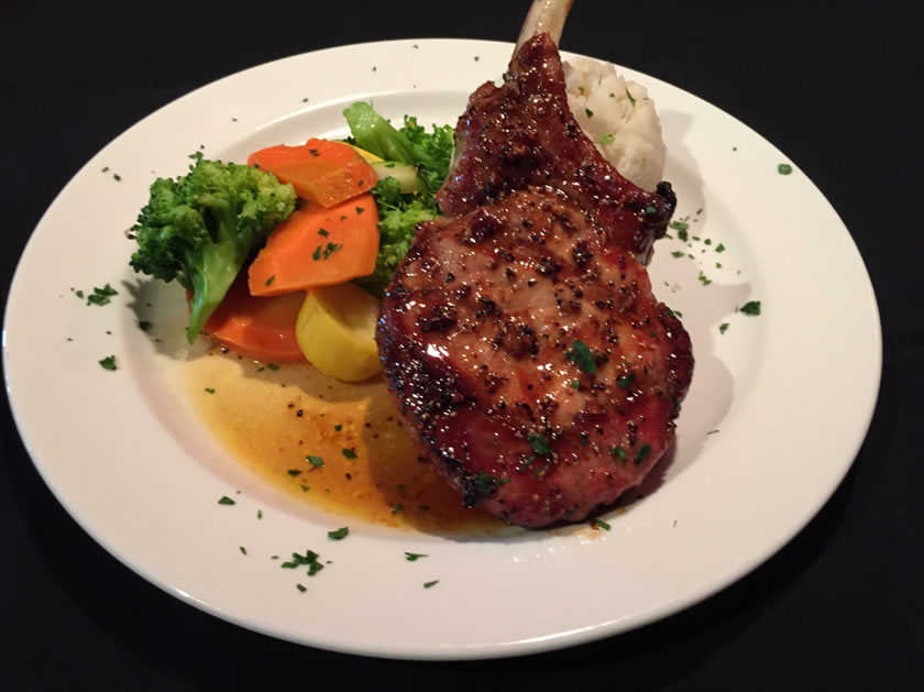 Grilled center cut pork chop with mashed potato and vegetables