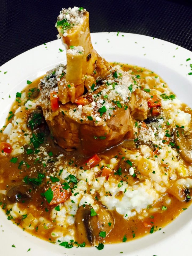Braised meat shank served over risotto with mushrooms