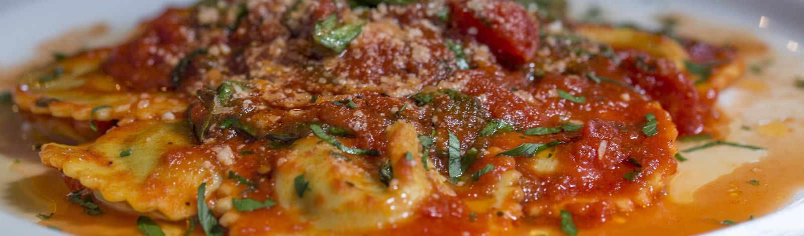 Cheese ravioli in homemade marinara sauce with fresh herbs