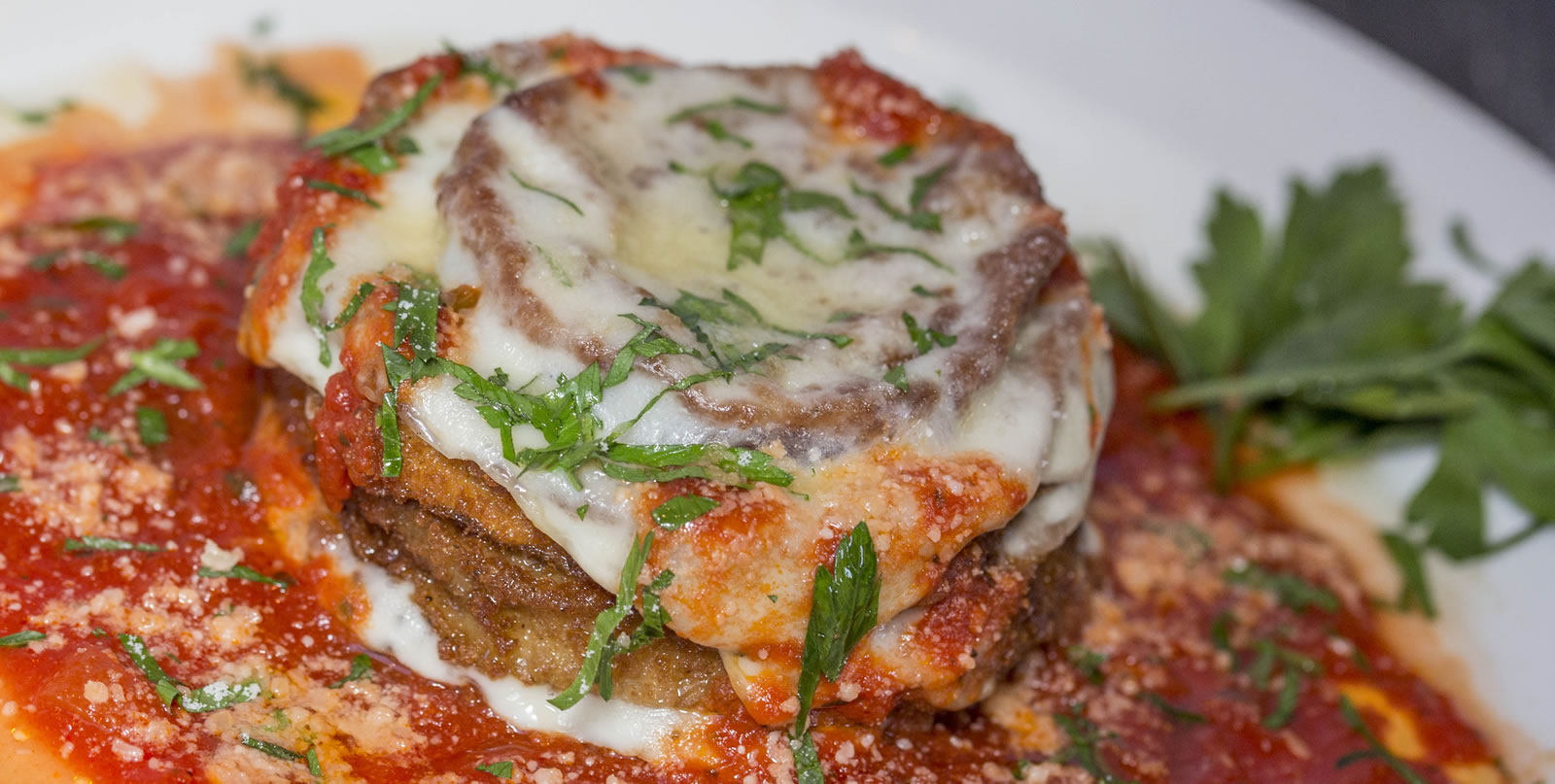 Eggplant stack with melted mozzarella, marinara and parsley