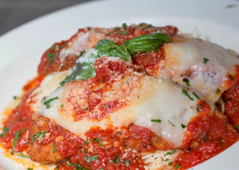 Chicken parmesan with homemade sauce, melted cheese and basil