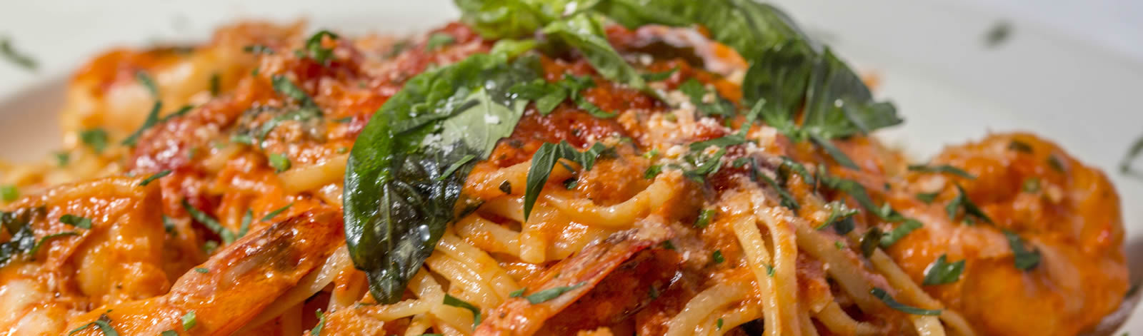 Shrimp scampi over linguini with marinara and basil