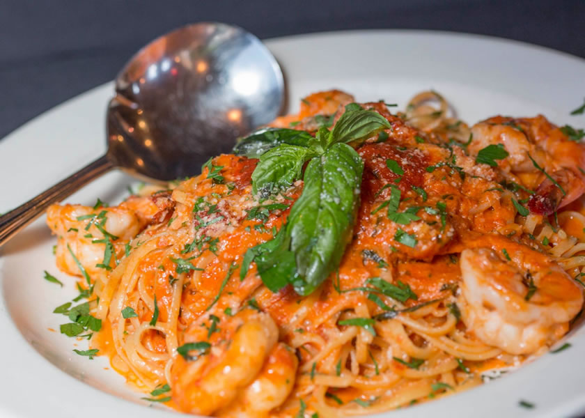 Jumbo shrimp over linguini in homemade marinara with fresh basil