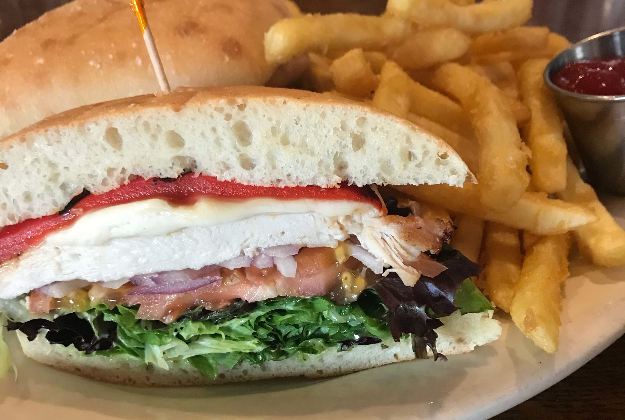 La Familia sandwich with grilled chicken, roasted red peppers and greens